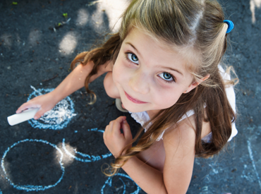 Girl with sidewalk chalk in New Hampshire